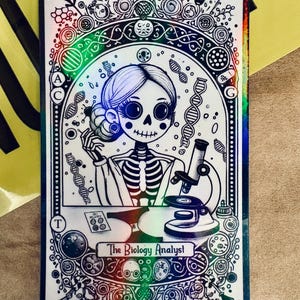 May include: A rectangular sticker with a holographic border features a black and white illustration of a skeleton in a lab coat. The image includes a microscope, DNA strands, and the text "The Biology Analyst - Female."