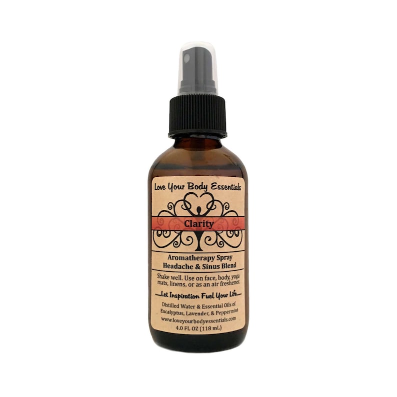 May include: A brown glass bottle with a black spray nozzle and a label that reads "Love Your Body Essentials Clarity Aromatherapy Spray Headache & Sinus Blend Shake well. Use on face, body, yoga mats, linens, or as an air freshener. Let Inspiration Fuel Your Life. Distilled Water & Essential Oils of Eucalyptus, Lavender, & Peppermint www.loveyourbodyessentials.com 4.0 FL OZ (118 ml)"