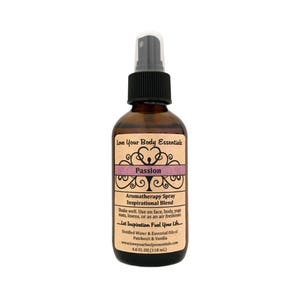 May include: A brown glass bottle with a black spray nozzle and a label that reads "Love Your Body Essentials Passion Aromatherapy Spray Inspirational Blend Shake well. Use on face, body, yoga mats, linens, or as an air freshener. Let Inspiration Fuel Your Life. Distilled Water & Essential Oils of Patchouli & Vanilla www.loveyourbodyessentials.com 4.0 FL OZ (118 ml.)"