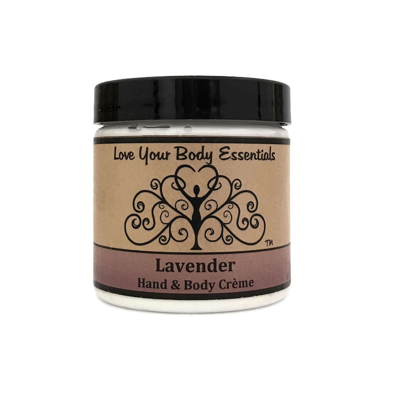 May include: A white jar with a black lid and a brown label. The label says "Love Your Body Essentials" and features a stylized tree with a woman inside. The jar also says "Lavender Hand & Body Cr&egrave;me".