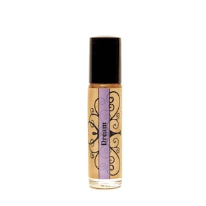 May include: A brown glass roller bottle with a black cap and a label that says "Dream" in a purple banner with a decorative floral design.