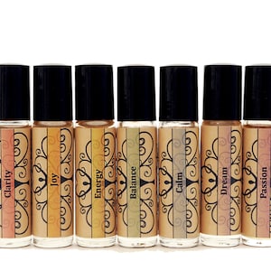 May include: Ten small glass bottles with black roll-on tops and labels with different colors and words. The words on the labels are: Clarity, Joy, Energy, Balance, Calm, Dream, Passion.