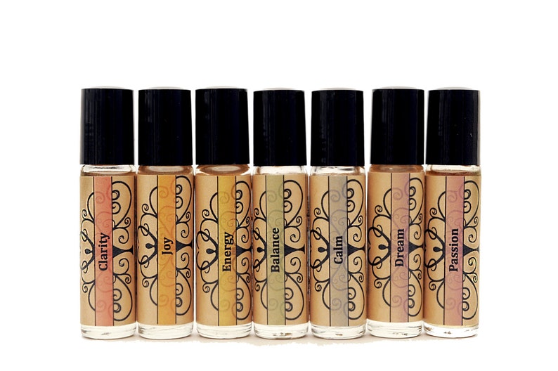May include: Ten small glass bottles with black roll-on tops and labels with different colors and words. The words on the labels are: Clarity, Joy, Energy, Balance, Calm, Dream, Passion.