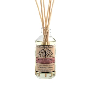 May include: A glass bottle reed diffuser with a brown label that reads "Love Your Body Essentials White Tea Ginger Reed Diffuser | Home Fragrance Flip reeds as needed to refresh scent...Awaken Your Senses...loveyourbodyessentials.com 4.0 FL OZ (118 mL)"