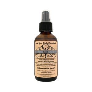 May include: A brown glass bottle with a black spray top and a label that reads "Love Your Body Essentials Calm Aromatherapy Spray Stress & Anxiety Blend Shake well. Use on face, body, yoga mats, linens, or as an air freshener. Let Inspiration Fuel Your Life. Distilled Water & Essential Oils of Lavender, & Orange www.loveyourbodyessentials.com 4.0 FL OZ (118 ml.)"