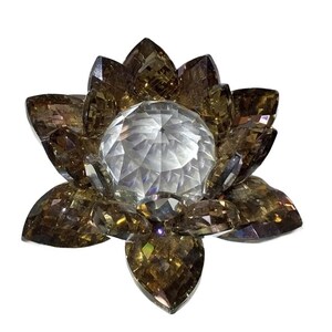 May include: A decorative crystal lotus flower with faceted petals in shades of brown and a central clear crystal sphere. The flower is designed to catch and reflect light, creating a sparkling effect.