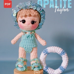 Puede incluir: Muñeca de ganchillo con un traje de baño azul, un gorro de lentejuelas y sandalias. La muñeca tiene mejillas rosadas y está junto a un salvavidas de ganchillo blanco y azul. El texto "OPALITE Taylor" y "CROCHET PATTERN" son visibles.