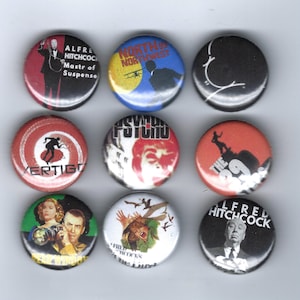 May include: Nine round pinback buttons featuring images and text related to Alfred Hitchcock films. The buttons display movie titles like "Vertigo" and "Psycho," along with portraits and silhouettes. Colors include red, black, white, blue, and green.