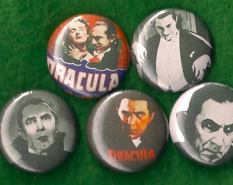 May include: Five round buttons with images of Dracula from the classic horror film. The buttons are black, white, and gray with red text. The text on the buttons reads "Dracula".