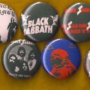 May include: Nine Black Sabbath band pinback buttons with various album covers and band logos. The buttons are round and feature images of the band members, album titles, and the band's name.