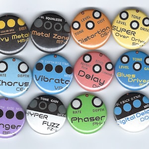 May include: Ten round buttons with different colored backgrounds and black text. Each button has a different name and abbreviation for a guitar effect pedal. The names include: Heavy Metal, Metal Zone, Distortion, Super Over Drive, Chorus, Vibrato, Delay, Blues Driver, Hyper Fuzz, Phaser, Flanger, and Digital Delay.