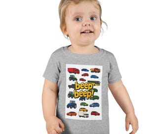 May include: A grey toddler t-shirt with a colourful graphic of vehicles, such as trucks, cars, and tractors. The text "beep beep!" is printed in yellow and green. The shirt is made of soft material.