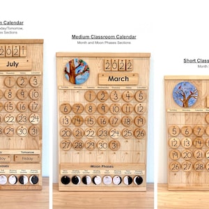 May include: Three wooden classroom calendars labelled Tall, Medium, and Short. Each features a light wood grain finish, circular numbered date tiles, a month display, and a year block. The tall and medium versions include moon phase icons.