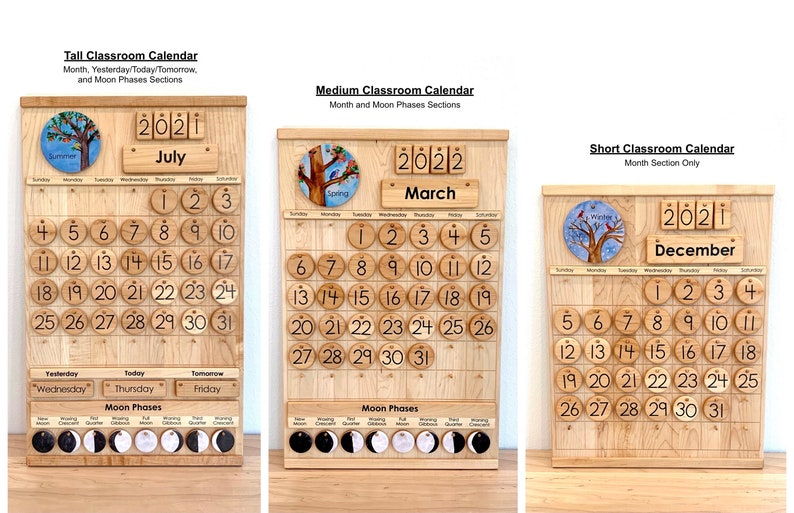 May include: Three wooden classroom calendars labelled Tall, Medium, and Short. Each features a light wood grain finish, circular numbered date tiles, a month display, and a year block. The tall and medium versions include moon phase icons.