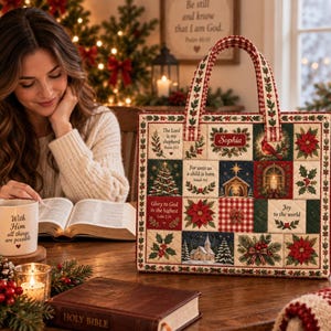 May include: A square quilted tote bag featuring a patchwork design of Christmas-themed illustrations, including a nativity scene, poinsettias, holly, and religious text. The bag has two fabric handles and a personalized name tag reading Sophia.