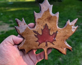 Maple leaf decoration: Wood with a dark red cutout