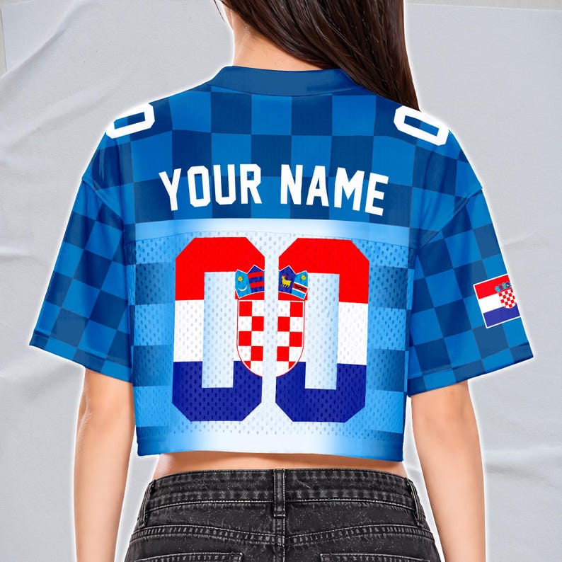 May include: Blue cropped jersey with a checkered pattern and the text "YOUR NAME" across the back. The jersey features the Croatian flag colors and emblem, with the number "00" prominently displayed. A Croatian flag is on the right sleeve.