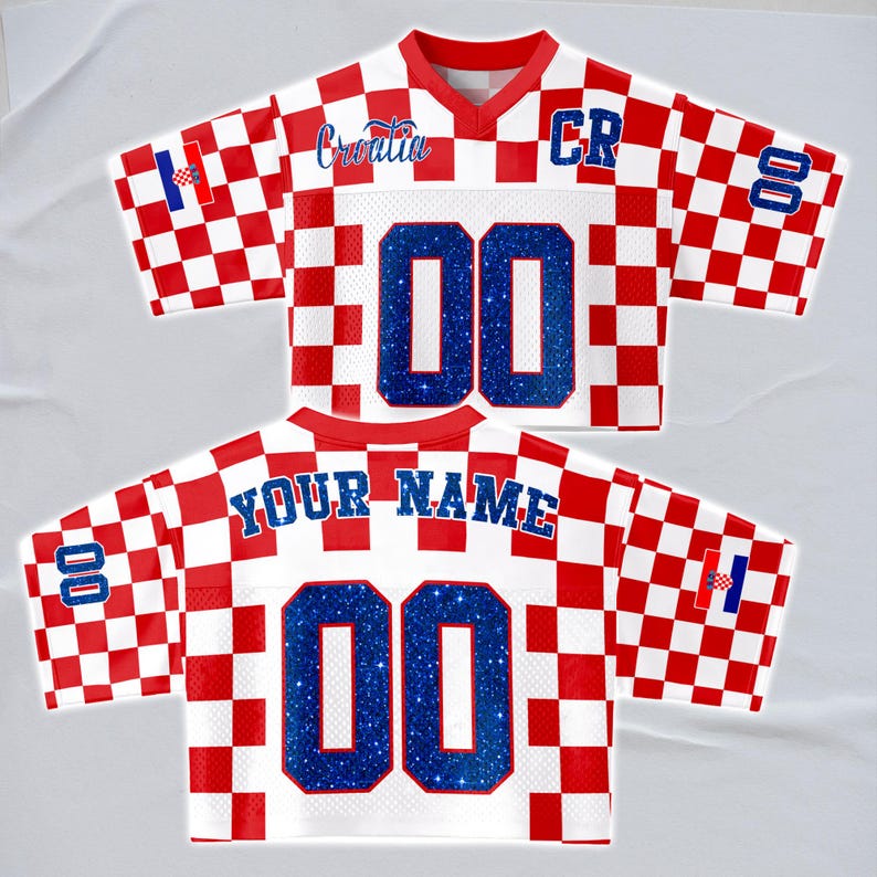 May include: A white and red checkered jersey with the word "Croatia" in blue script. The jersey has the number "00" in blue glitter on the front and back. The sleeves have the Croatian flag and the number "00". The back of the jersey says "YOUR NAME".