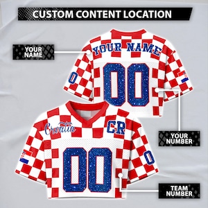 May include: Two white and red checkered sports jerseys. The jerseys have the word "Croatia" and the letters "CR" on them. The number "00" is displayed in blue glitter. The text "YOUR NAME" and "YOUR NUMBER" are also visible.