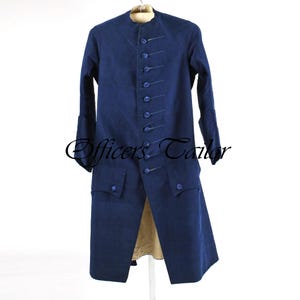 May include: A long, navy blue coat with a mandarin collar and multiple button closures. The coat features two front pockets and long sleeves with buttoned cuffs. The text "Officers Tailor" is visible on the coat.