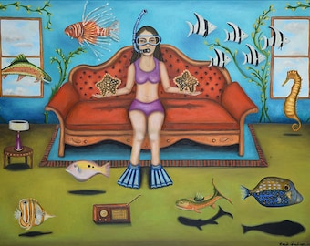 May include: A woman wearing a purple swimsuit and a diving mask sits on a red couch in a room with a blue wall.  She is holding two starfish.  There are fish and a seahorse floating in the air around her.