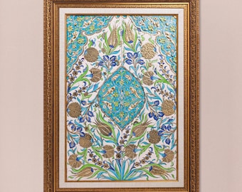 May include: A framed artwork with an ornate gold frame. The artwork features a central turquoise diamond shape surrounded by floral and botanical elements in shades of blue, green, and gold. The background is white.