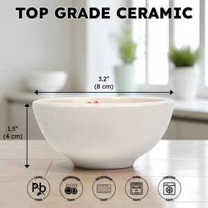 May include: A white ceramic bowl, 3.2 inches (8 cm) in diameter and 1.5 inches (4 cm) tall, with the text "TOP GRADE CERAMIC." The bowl is lead-free, dishwasher, microwave, oven, and freezer safe.