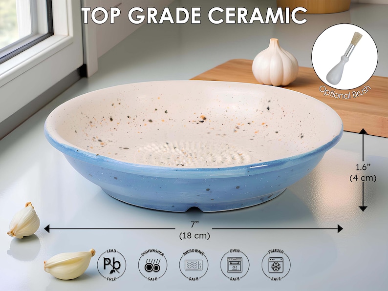 May include: A ceramic garlic grater bowl with a blue rim and a white interior speckled with brown. The bowl is 18 cm in diameter and 4 cm high. The text "TOP GRADE CERAMIC" is at the top.