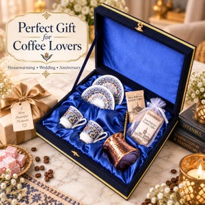 May include: A navy blue velvet gift box lined with blue satin containing two white ceramic cups with colorful floral patterns, two matching saucers, a hammered copper coffee pot, a gold-toned stirrer, and two packets of Turkish coffee.