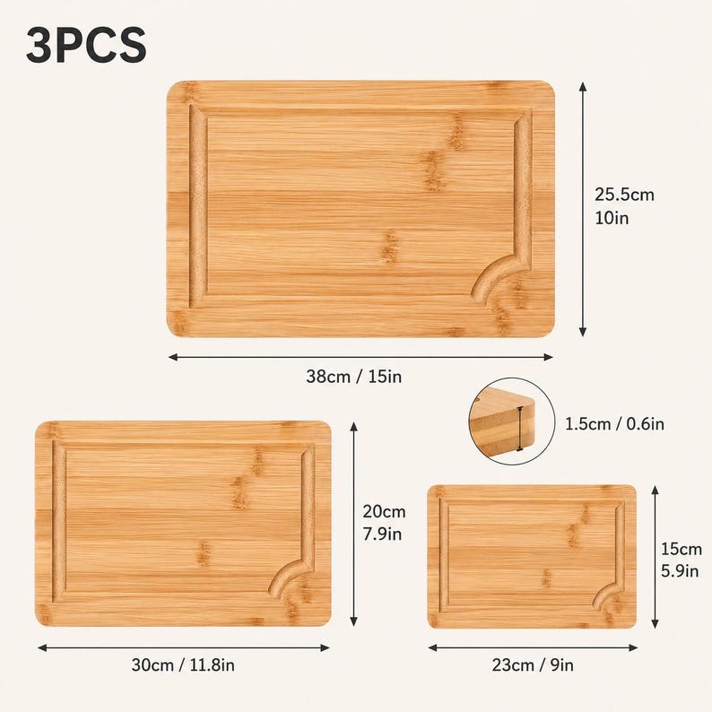 May include: A set of 3 rectangular bamboo cutting boards with juice grooves. The largest measures 15 inches by 10 inches, the medium 11.8 inches by 7.9 inches, and the smallest 9 inches by 5.9 inches. All boards have a thickness of 0.6 inches.