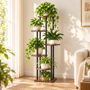 May include: A tall, multi-tiered plant stand featuring a black metal frame and dark wood-toned shelves. The structure holds six potted plants of varying sizes, including trailing vines, leafy green foliage, and white flowering peace lilies.