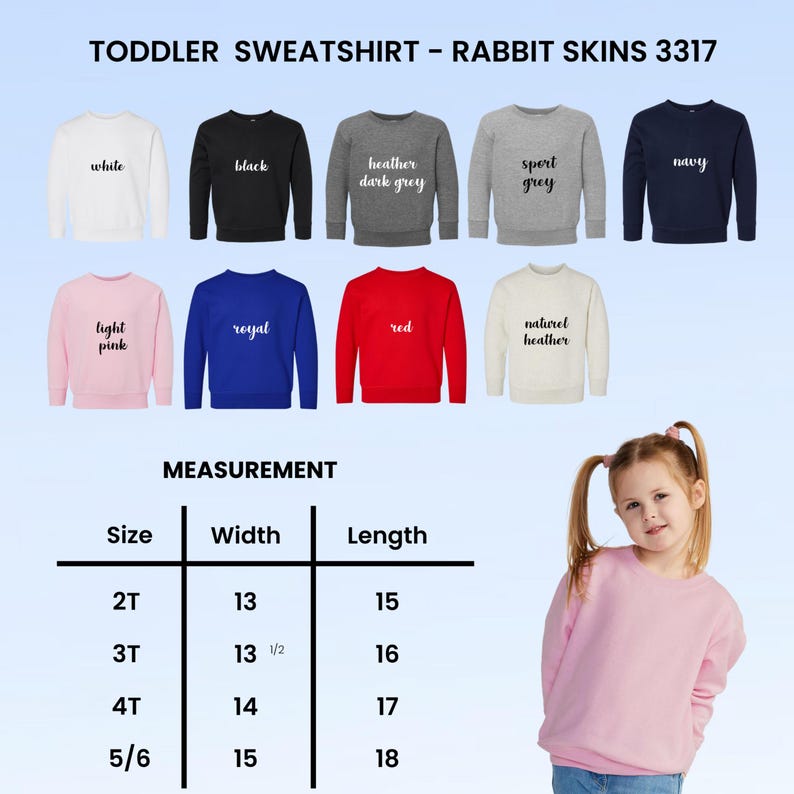 Puede incluir: Una selecci&oacute;n de sudaderas para ni&ntilde;os peque&ntilde;os en varios colores, incluyendo blanco, negro y azul marino. La imagen muestra las sudaderas con el texto "TODDLER SWEATSHIRT - RABBIT SKINS 3317". Una tabla de medidas muestra tallas 2T a 5/6 con ancho y largo en cm.