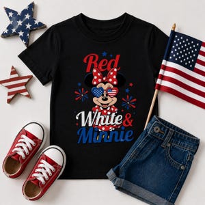 K&ouml;nnte beinhalten: Schwarzes T-Shirt mit Minnie Mouse im patriotischen Stil, mit roter Schleife und Sonnenbrille. Der Text lautet "Red White & Minnie". Enth&auml;lt rote Turnschuhe, Jeansshorts und eine kleine amerikanische Flagge.