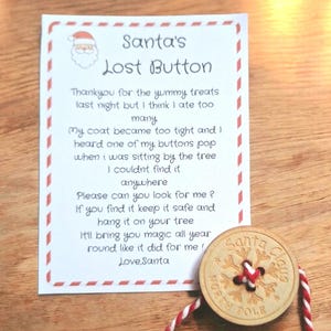 May include: A rectangular white card with red dashed borders featuring a Santa Claus icon and the text Santa's Lost Button followed by a message from Santa. A round wooden button with snowflake engravings and the text Santa Claus North Pole.