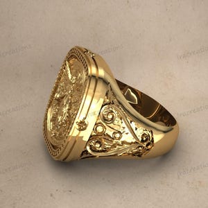 Unisex silver signet ring with angelic design.