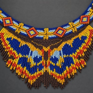 May include: A wide, crescent-shaped statement necklace crafted from intricate beadwork. The design features a vibrant color palette of royal blue, bright yellow, orange, light blue, and dark brown, arranged in geometric patterns and fringe details.