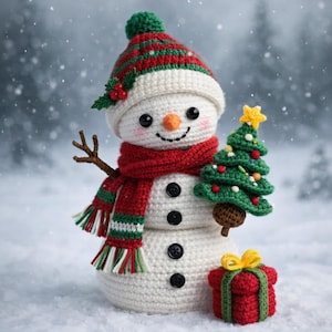 May include: A crocheted snowman with a red scarf and hat, holding a green Christmas tree and a red present. The snowman has a carrot nose, black button eyes, and a smiling mouth. The hat is striped red and green.