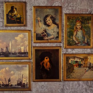 May include: A collection of framed vintage art prints. Features portraits of children, a seascape with sailing boats, and a portrait of a man with a long beard. Each print is in a gold-coloured frame.