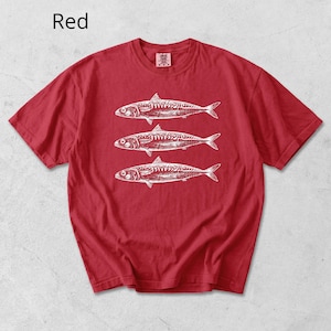 May include: Red t-shirt with a white illustration of three fish. The word "Red" is printed in white in the upper left corner. The shirt is made of a soft material and has short sleeves.
