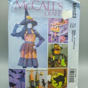 May include: A sewing pattern for a witch costume and Halloween decorations. The pattern includes instructions for making a witch's dress, hat, and boots, as well as a pumpkin, cat, and bat decorations. The pattern is from McCall's Craft and is size Miss (Sml-Med-Lrg).