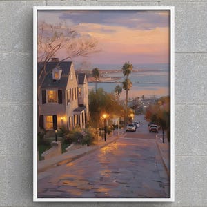 Peut inclure: Peinture encadrée d'une ville côtière au crépuscule. L'œuvre représente une rue menant à l'océan, bordée de lampadaires et de bâtiments. Le ciel passe du rose au bleu, créant une atmosphère sereine.