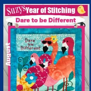 May include: A vibrant textile artwork depicting flamingos wearing sunglasses, with the text "Dare to be Different" and "August". The design features a turquoise background and floral details, showcasing a playful theme.