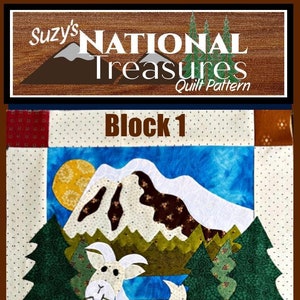 Peut inclure: Un bloc de courtepointe représentant une chèvre blanche avec une vigne verte dans sa bouche, une chaîne de montagnes avec un sommet brun, des arbres verts et un soleil jaune. Le bloc est intitulé "Bloc 1" et porte le texte "MT. RAINIER NATIONAL PARK" dans le coin inférieur droit.