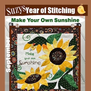 Op de afbeelding: Een gewatteerde wandhanger met zonnebloemen met gele bloemblaadjes en donkerbruine centra. De tekst "Make your own Sunshine" wordt weergegeven. De bovenste banner luidt "Suzy's Year of Stitching" en "Make Your Own Sunshine". Het woord "September" staat aan de linkerkant.