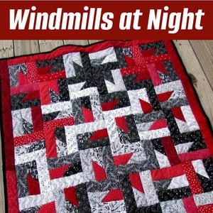 May include: A handmade quilt with a patchwork design. The quilt features a repeating pattern of red, black, white, and gray fabrics. The text "Windmills at Night" is at the top. The website "SuzyssSitcom.com" is at the bottom.