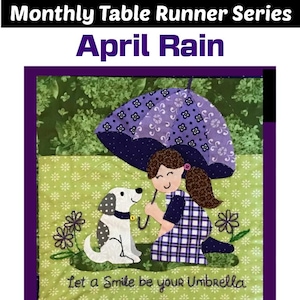 May include: A table runner featuring a girl and a dog under an umbrella with the text "Let a Smile be your Umbrella". The design is in shades of green, purple, and white.