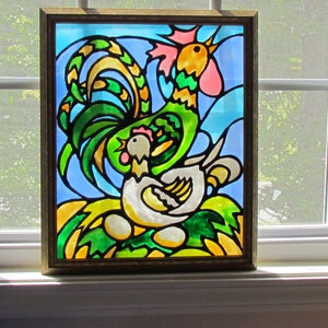 May include: A stained glass window depicting a rooster and a hen. The rooster is green, yellow, and pink, with a large, elaborate tail. The hen is white with a pink comb. The background is blue and green.