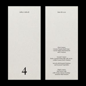 May include: Two-page menu on textured off-white paper. The left page has the number 4 in black. The right page lists a three-course meal: Creamy Tomato Basil Soup, Herb-Crusted Prime Rib, and Red Velvet Cake. The date is June 6th, 2026.