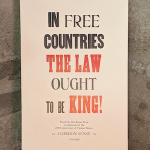 May include: A set of three ceramic mugs with a speckled, matte finish. The mugs are in shades of cream, light gray, and dark gray. Each mug has a simple, minimalist design and a rounded handle.