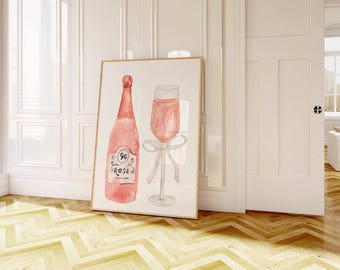 May include: Watercolour print featuring a pink rosé wine bottle and a champagne glass with a white bow. The bottle has a label that reads "90 Rose". The artwork is framed in a light wood frame.